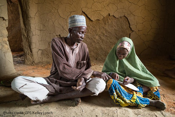 Grandfather and village chief Mai Unguwa Ali Abdullahi sits with his granddaughter Mariam Isah, 8, in Nigeria. The village chief wants his granddaughter to become a doctor or nurse to help her community but Mariam wants to become a teacher to help other children learn.