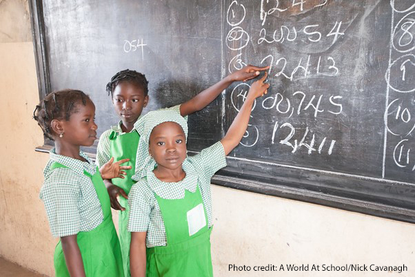 Three girl students at the blackboard in Kuje primary school in Abuja, Nigeria