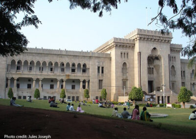 adult students sitting outside at Osmania University, India.