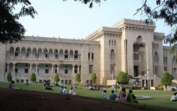 adult students sitting outside at Osmania University, India.