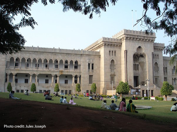 adult students sitting outside at Osmania University, India.