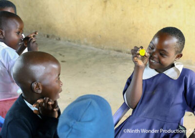 Irene, a pupil at one of the project schools, interacts with other children in her class