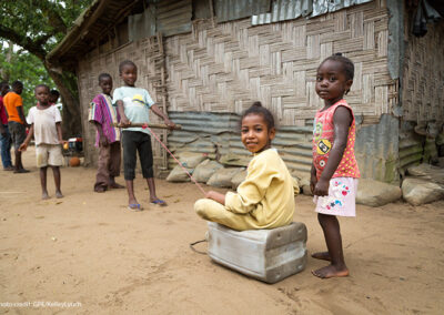 Children play with their ‘car’ (a plastic jerry can), in the ‘street’; VOA-1 community, Montserrado County, Liberia.