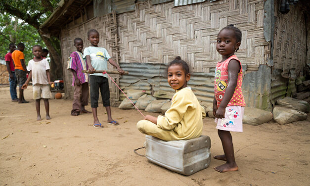 Children play with their ‘car’ (a plastic jerry can), in the ‘street’; VOA-1 community, Montserrado County, Liberia.