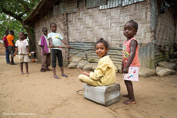 Children play with their ‘car’ (a plastic jerry can), in the ‘street’; VOA-1 community, Montserrado County, Liberia.