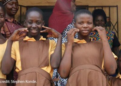 Girl from photo below signing ‘thank you’ for enabling her to attend school. STAGE project staff are continuously monitoring the well-being of all girls.