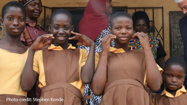 Girl from photo below signing ‘thank you’ for enabling her to attend school. STAGE project staff are continuously monitoring the well-being of all girls.