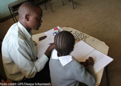 A male enumerator gives the Early Grade Mathematics Assessment to a girl in the Marikani Government School, Nairobi, Kenya.