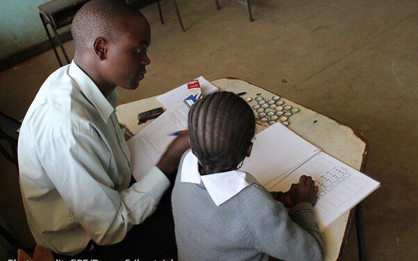 A male enumerator gives the Early Grade Mathematics Assessment to a girl in the Marikani Government School, Nairobi, Kenya.