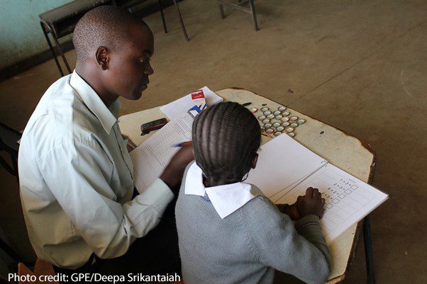 A male enumerator gives the Early Grade Mathematics Assessment to a girl in the Marikani Government School, Nairobi, Kenya.