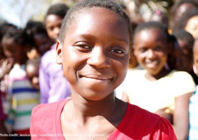 Twelve-year-old Suria smiles directly at the camera. The Adolescent Girls Empowerment Program – led by the Population Council – is currently helping more than 10,000 girls like Suria benefit from safe spaces in Zambia.