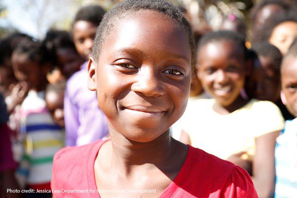 Twelve-year-old Suria smiles directly at the camera. The Adolescent Girls Empowerment Program – led by the Population Council – is currently helping more than 10,000 girls like Suria benefit from safe spaces in Zambia.