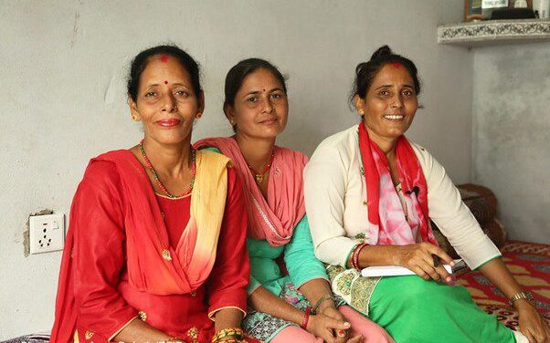 3 Nepali women - Community worker Maya with returnee migrants Bimala and Sumitra, Nepal.