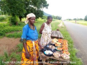 Women Selling mushrooms at the side of the road. 
