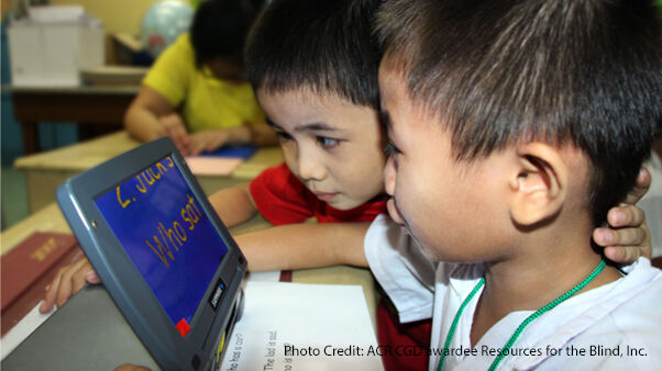 children with visual impairment look at an assistive screen
