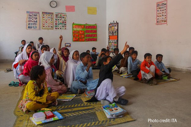 Pre-primary school children sit on the floor in an early childhood education class in Punjab, Pakistan.