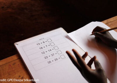 Student using his fingers to solve a problem on the Early Grade Mathematics Assessment (EGMA), Nairobi, Kenya.