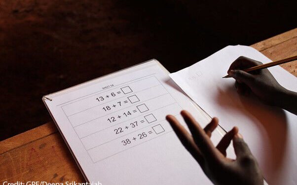 Student using his fingers to solve a problem on the Early Grade Mathematics Assessment (EGMA), Nairobi, Kenya.