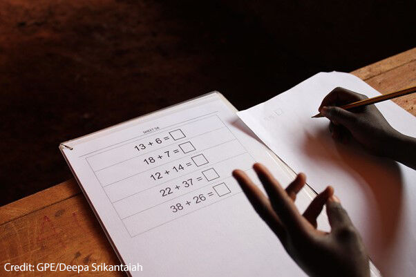 Student using his fingers to solve a problem on the Early Grade Mathematics Assessment (EGMA), Nairobi, Kenya.