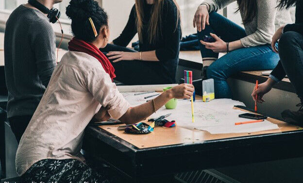 A group of students meet to discuss coursework