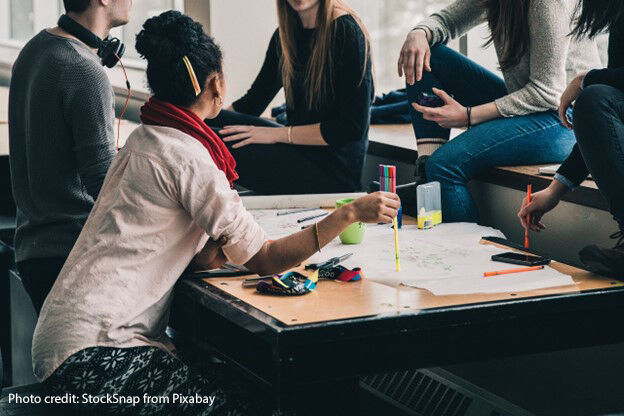 A group of students meet to discuss coursework