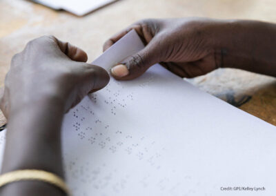 Hands reading a braille page. A blind student at Sebeta School for the Blind checks her answers after taking a geography exam; Sebeta, Oromia, Ethiopia.