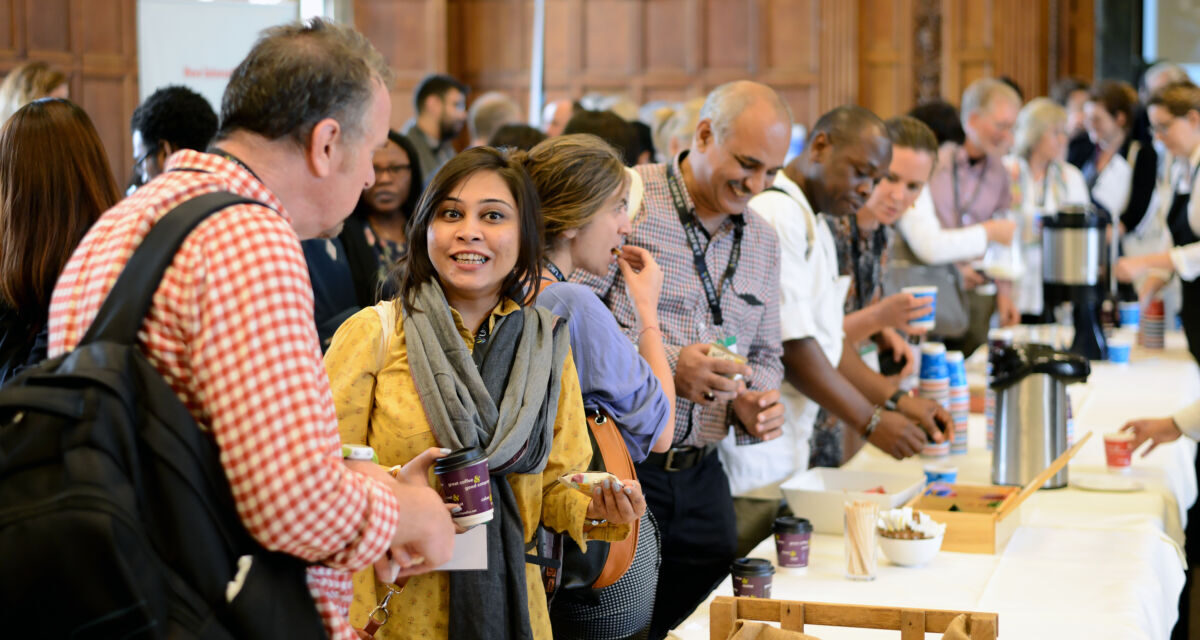 A group of people collecting coffee and chatting . Image from UKFIET Conference 2017