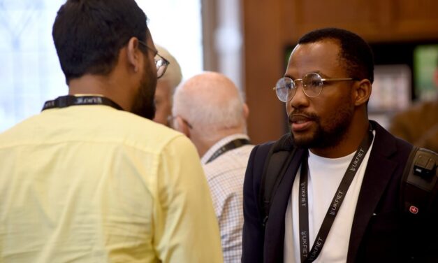 Daniel Hawkins Iddrisu chats to another conference participant during a coffee break.