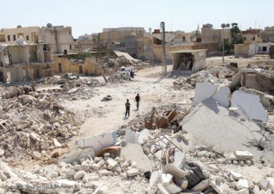 Children in rubble of demolished buildings due to conflict in Syria