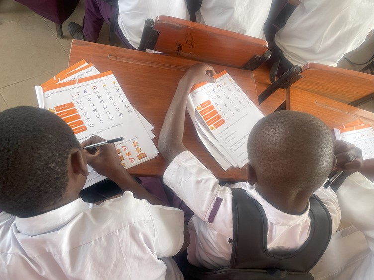 Students from Charambe Secondary School filling out comfort survey, Temeke District - Dar es Salaam, Tanzania.