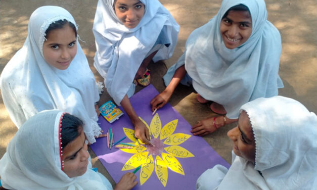 a group of girls sit around and create a flower with each petal being a key positive character attribute, such as: loving, bold, lovely good friend, strong, bold, etc.