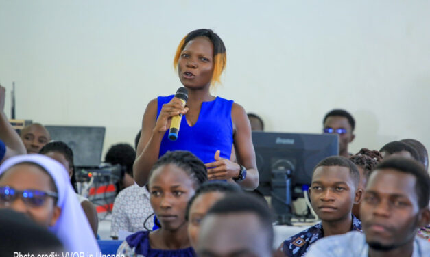 Female student-teacher in blue top asks a question during a career talk at Gulu University (September 2023).