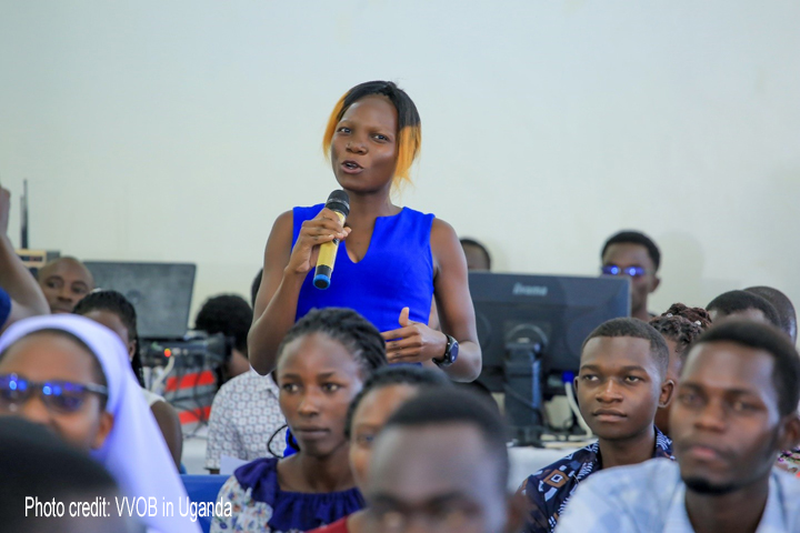 Female student-teacher in blue top asks a question during a career talk at Gulu University (September 2023).