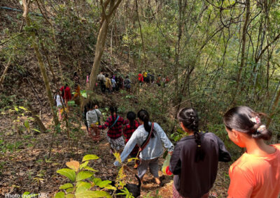 Students returning home through woodland from school from their temporary school site in Karin State, February 2023.