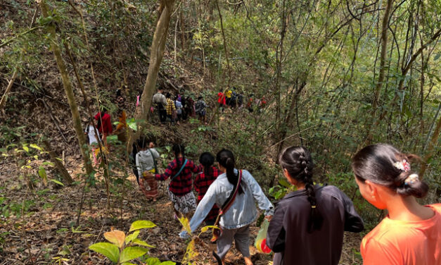 Students returning home through woodland from school from their temporary school site in Karin State, February 2023.