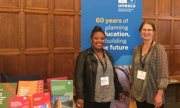 Sally Rosscornes and Fabricia Devignes by a UNESCO 60 years of planning education banner.