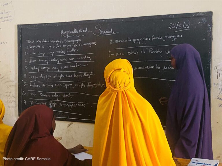 Girls look at the blackboard together in a classroom, Somalia.