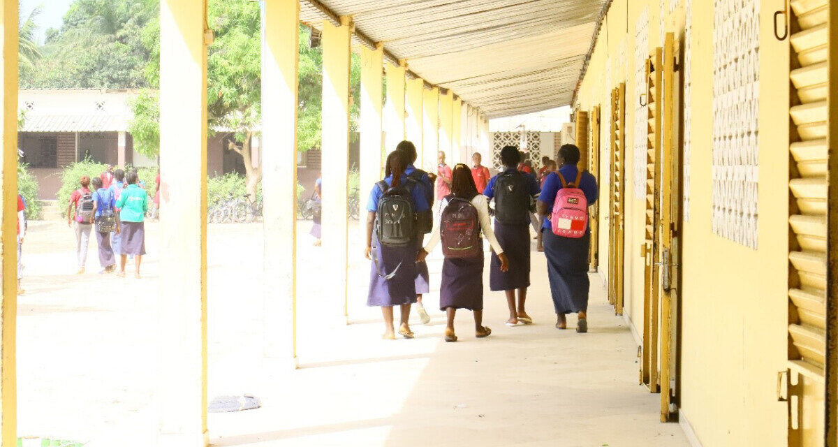 Students leaving class in a high school compound, Senegal.
