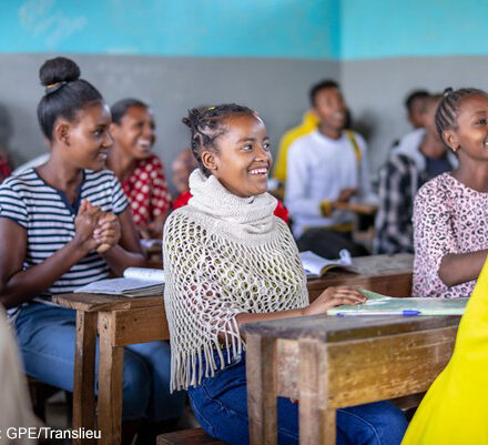 Students sitting and laughing in a classroom at Yirba Yanase Primary and Secondary School in Hawassa, Ethiopia.