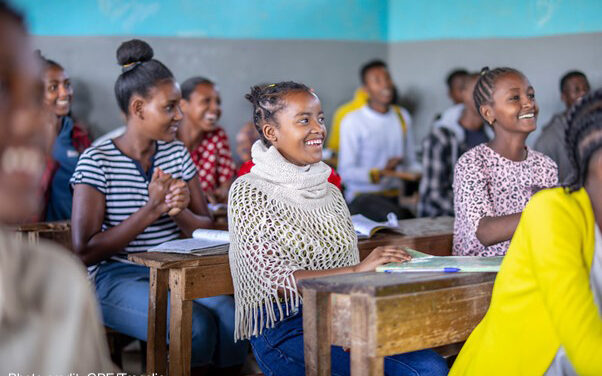 Students sitting and laughing in a classroom at Yirba Yanase Primary and Secondary School in Hawassa, Ethiopia.