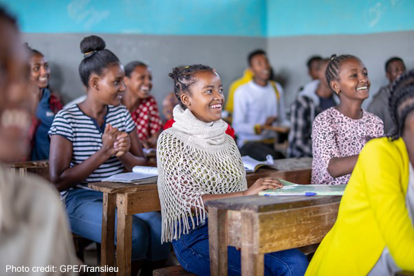 Students sitting and laughing in a classroom at Yirba Yanase Primary and Secondary School in Hawassa, Ethiopia.
