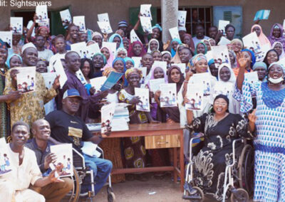 People in Nigeria celebrate the launch of a guide that will help parents of children with disabilities support their child’s education.