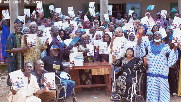 People in Nigeria celebrate the launch of a guide that will help parents of children with disabilities support their child’s education.