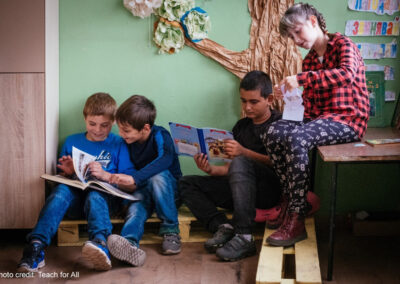 Children look at books together in their primary school class, Bulgaria.