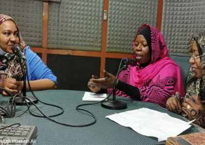 Staff from the university have a discussion in a radio broadcasting room.