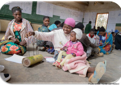 Learner with baby in a community-based accelerated learning centre, Malawi.