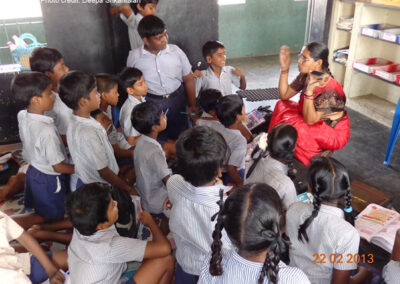 A primary school teacher shows her mobile phone to the class, Chennai, India.