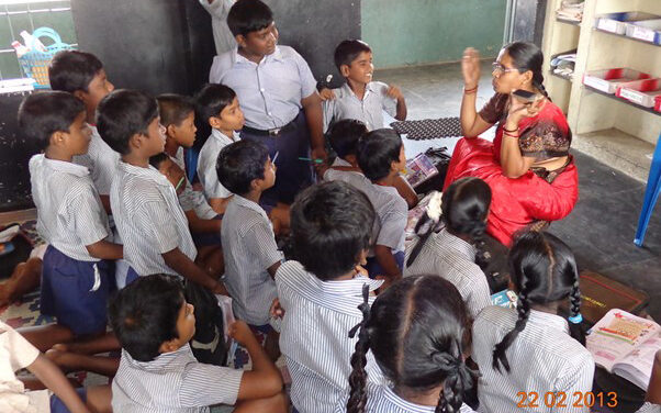 A primary school teacher shows her mobile phone to the class, Chennai, India.