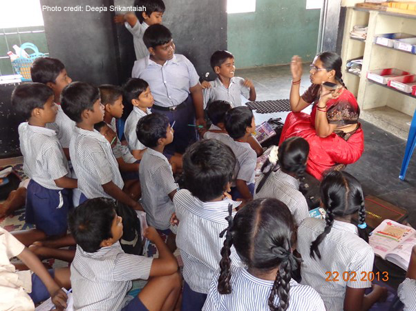 A primary school teacher shows her mobile phone to the class, Chennai, India.