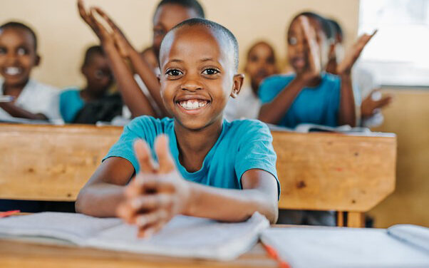 Close up of a girl clapping in class, Kamonyi, Rwanda
